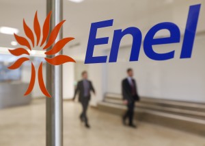 People walk past the logo of Italy's biggest utility Enel at their Rome headquarter